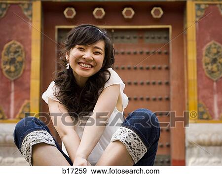 Teenage girl sitting outdoors smiling View Large Photo Image Stock Photo - Teenage girl sitting outdoors smiling. Fotosearch