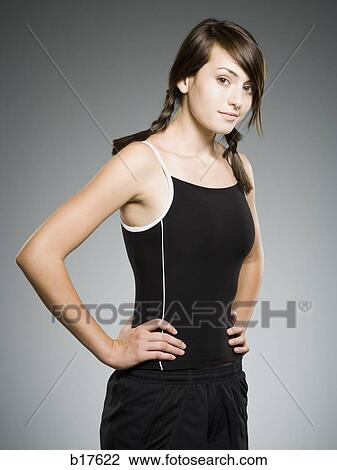 Teenage girl smiling with hands on hips View Large Photo Image Stock Image - Teenage girl smiling with hands on hips. Fotosearch