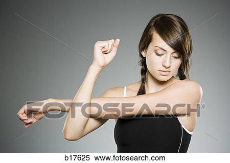 Teenage girl stretching arms View Large Photo Image Stock Photography - Teenage girl stretching arms. Fotosearch