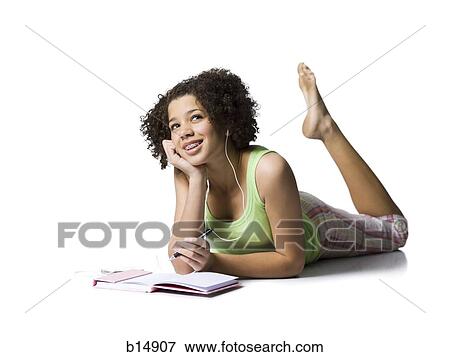 Teenage girl with braces and ear buds lying down smiling View Large Photo Image Stock Photo - Teenage girl with braces and ear buds lying down smiling. Fotosearch
