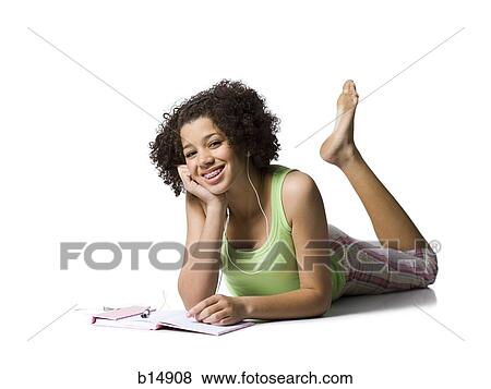 Teenage girl with braces and ear buds lying down smiling View Large Photo Image Stock Photo - Teenage girl with braces and ear buds lying down smiling. Fotosearch