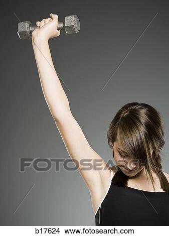 Teenage girl with dumbbell View Large Photo Image Picture - Teenage girl with dumbbell. Fotosearch
