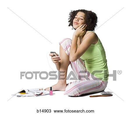 Teenage girl with MP3 player listening to music with eyes closed View Large Photo Image Stock Image - Teenage girl with MP3 player listening to music with eyes closed. Fotosearch