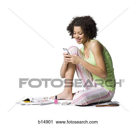 Teenage girl with MP3 player sitting and listening to music View Large Photo Image Stock Image - Teenage girl with MP3 player sitting and listening to music. Fotosearch