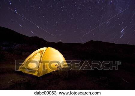 Tent at night outdoors with stars and light trails View Large Photo Image Stock Image - Tent at night outdoors with stars and light trails. Fotosearch