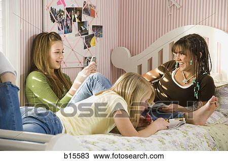 Three girls in bedroom with mp3 player View Large Photo Image Stock Image - Three girls in bedroom with mp3 player. Fotosearch