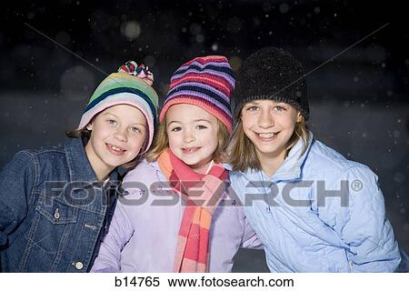 Stock Photography - Three girls outdoors in winter. Fotosearch