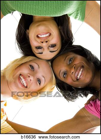 Three women hugging and smiling View Large Photo Image Stock Photograph - Three women hugging and smiling. Fotosearch