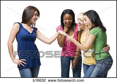 Three women looking at other woman's engagement ring smiling View Large Photo Image Stock Image - Three women looking at other woman's engagement ring smiling. Fotosearch