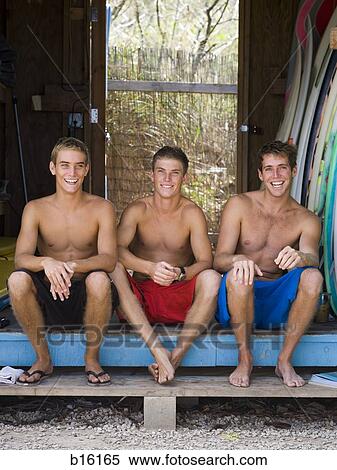 Three young men sitting outdoors View Large Photo Image Stock Photography - Three young men sitting outdoors. Fotosearch