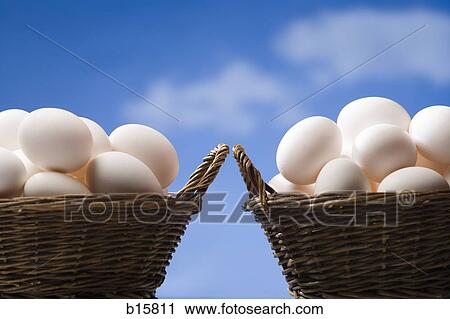 Two baskets filled with eggs outdoors with blue sky View Large Photo Image Stock Image - Two baskets filled with eggs outdoors with blue sky. Fotosearch