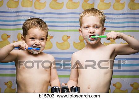 Two boys brushing teeth in bathroom sink View Large Photo Image Stock Image - Two boys brushing teeth in bathroom sink. Fotosearch