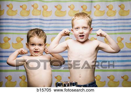 Two boys flexing muscles in bathroom View Large Photo Image Stock Photography - Two boys flexing muscles in bathroom. Fotosearch