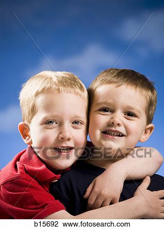 Two boys hugging and smiling View Large Photo Image Stock Image - Two boys hugging and smiling. Fotosearch