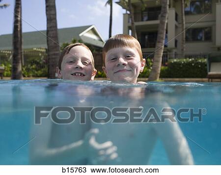 Two boys in outdoor pool smiling View Large Photo Image Stock Image - Two boys in outdoor pool smiling. Fotosearch