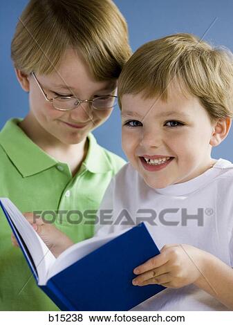 Two boys reading book View Large Photo Image Stock Photo - Two boys reading book. Fotosearch