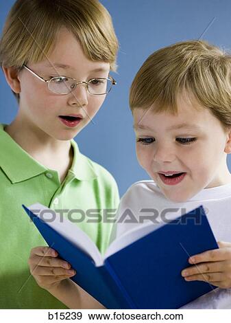 Two boys reading book View Large Photo Image Stock Photo - Two boys reading book. Fotosearch