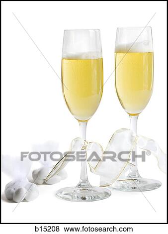 Stock Photo - Two champagne flutes with champagne and ribbons with hard candies. Fotosearch