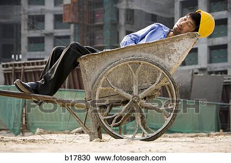 Stock Image - Two construction workers on the job site.. Fotosearch