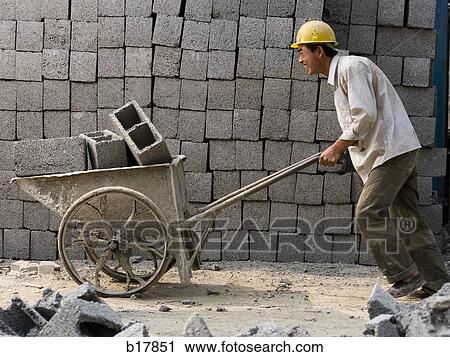 Stock Image - Two construction workers on the job site.. Fotosearch