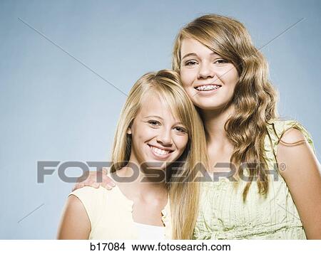Two girls embracing and smiling View Large Photo Image Picture - Two girls embracing and smiling. Fotosearch