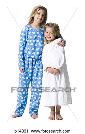 Two girls in pajamas hugging and smiling View Large Photo Image Stock Image - Two girls in pajamas hugging and smiling. Fotosearch