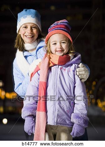 Two girls outdoors in winter smiling View Large Photo Image Stock Photo - Two girls outdoors in winter smiling. Fotosearch