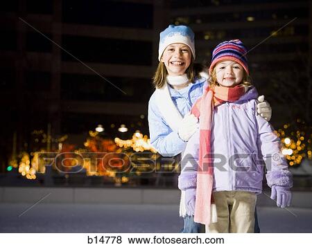 Two girls outdoors in winter smiling View Large Photo Image Stock Photo - Two girls outdoors in winter smiling. Fotosearch