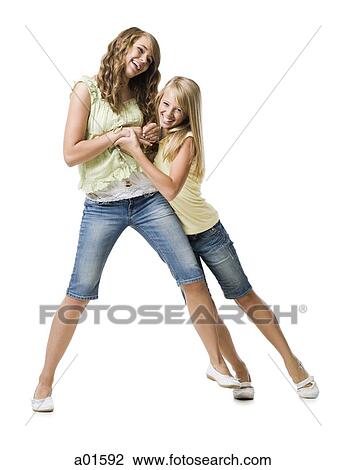 Two girls play fighting and smiling View Large Photo Image Stock Image - Two girls play fighting and smiling. Fotosearch