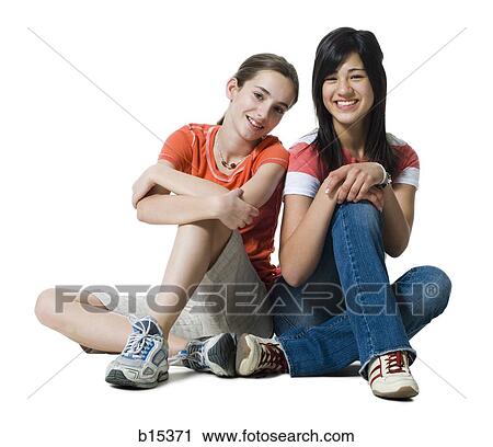 Stock Image - Two girls sitting and smiling. Fotosearch