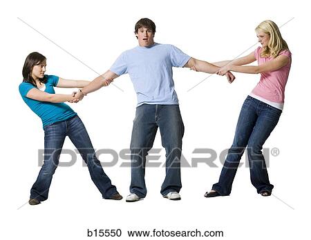 Two girls tugging at arms of boy View Large Photo Image Stock Image - Two girls tugging at arms of boy. Fotosearch