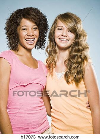 Two girls with braces embracing and smiling View Large Photo Image Stock Image - Two girls with braces embracing and smiling. Fotosearch