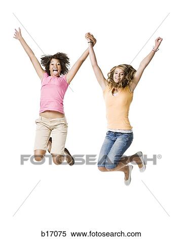 Two girls with braces holding hands and leaping View Large Photo Image Stock Photography - Two girls with braces holding hands and leaping. Fotosearch