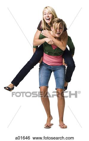 Two teenage girls laughing and giving piggy back ride View Large Photo Image Stock Photograph - Two teenage girls laughing and giving piggy back ride. Fotosearch