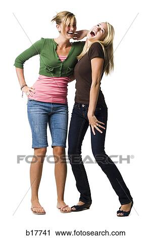 Stock Image - Two teenage girls posing and laughing. Fotosearch