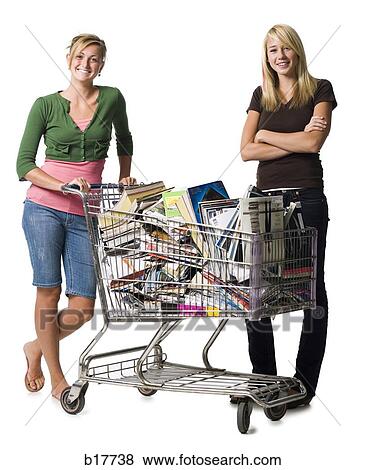Stock Photo - Two teenage girls with shopping cart filled with books and magazines. Fotosearch