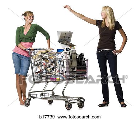 Two teenage girls with shopping cart filled with books and magazines View Large Photo Image Stock Photo - Two teenage girls with shopping cart filled with books and magazines. Fotosearch