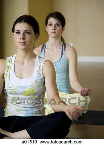 Two women doing yoga View Large Photo Image Stock Image - Two women doing yoga. Fotosearch