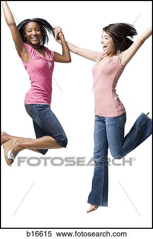 Two women holding hands and jumping View Large Photo Image Stock Photography - Two women holding hands and jumping. Fotosearch