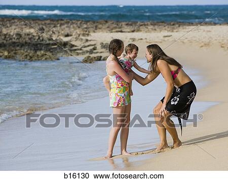 Two women with baby on beach View Large Photo Image Stock Image - Two women with baby on beach. Fotosearch