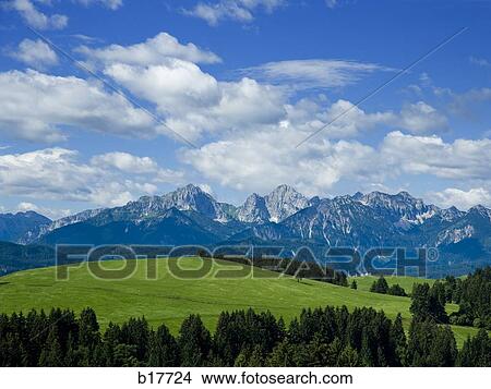 Picture - Valley and mountains with blue sky and clouds. Fotosearch