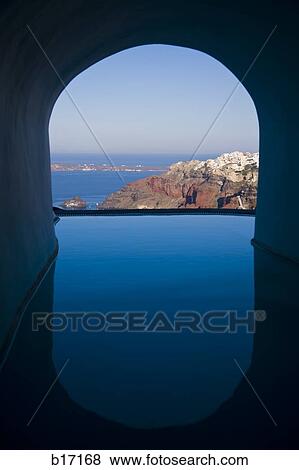 View of infinity pool through archway with mountains and water View Large Photo Image Stock Photo - View of infinity pool through archway with mountains and water. Fotosearch
