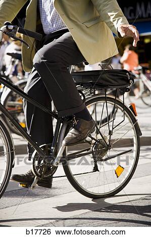 Waist down view of man riding bicycle View Large Photo Image Stock Photograph - Waist down view of man riding bicycle. Fotosearch