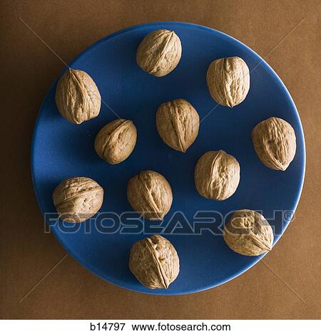 Walnuts on blue plate View Large Photo Image Stock Photo - Walnuts on blue plate. Fotosearch