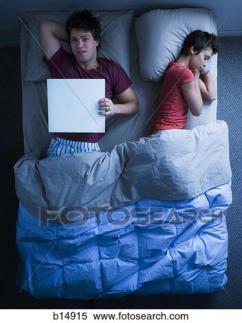 Woman asleep in bed and man holding blank sign View Large Photo Image Stock Photography - Woman asleep in bed and man holding blank sign. Fotosearch