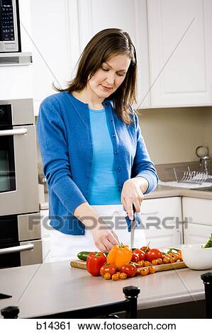 woman cutting vegetables and cooking View Large Photo Image Stock Image - woman cutting vegetables and cooking. Fotosearch