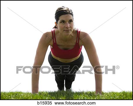 Woman doing pushups on grass outdoors View Large Photo Image Stock Photography - Woman doing pushups on grass outdoors. Fotosearch