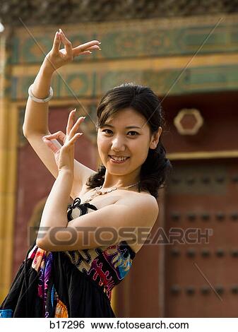 Woman doing tai chi outdoors smiling View Large Photo Image Stock Photograph - Woman doing tai chi outdoors smiling. Fotosearch