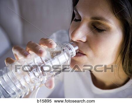Woman drinking bottled water View Large Photo Image Stock Photography - Woman drinking bottled water. Fotosearch