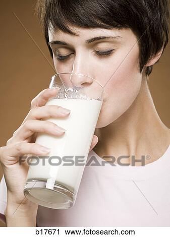 Woman drinking glass of milk View Large Photo Image Stock Image - Woman drinking glass of milk. Fotosearch